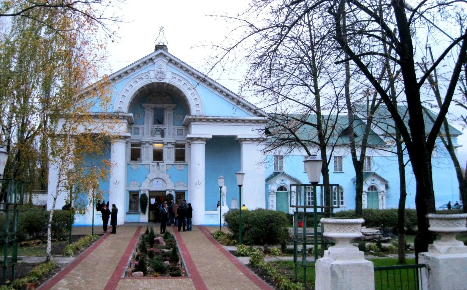Блакитна будівля культури з колонадою та прилеглою територією
